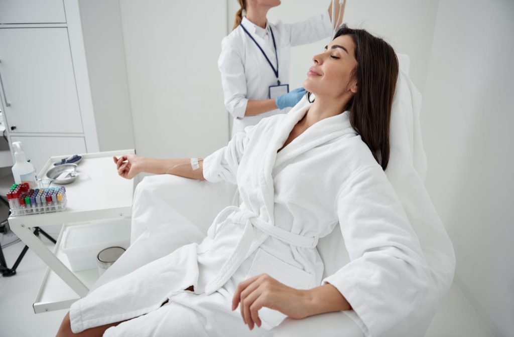 Woman relaxing while receiving a vitamin injection