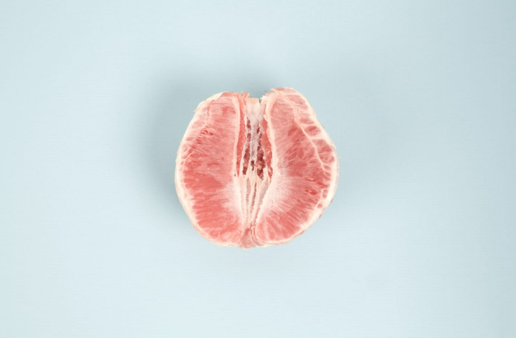 Half of a peeled grapefruit that resembles a tightened vaginal opening.
