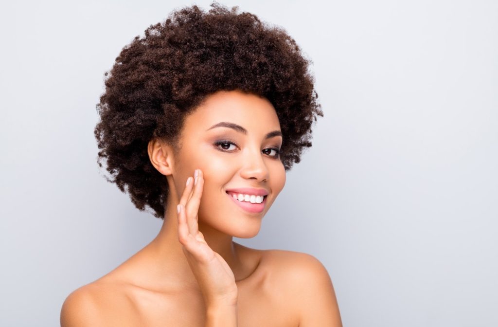 A woman smiling with clear skin. 