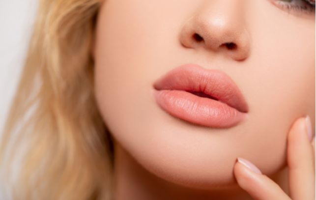 Close up of young woman with lip injections