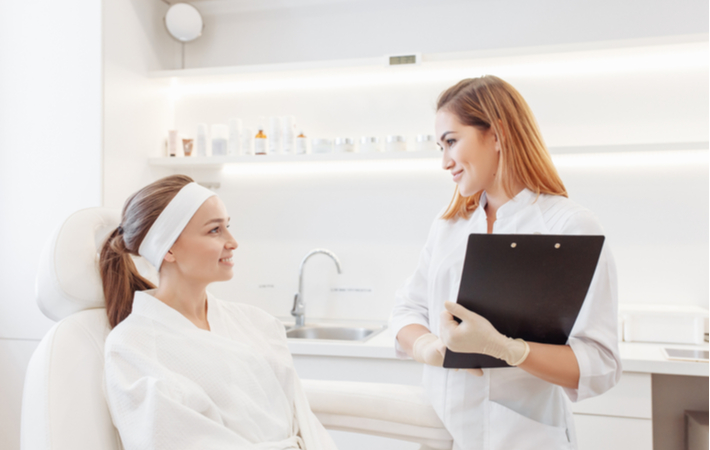 Women consulting with professional regarding dermal filler options
