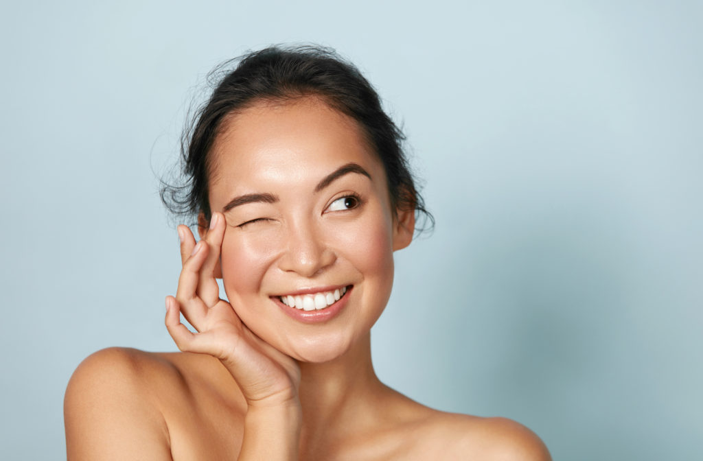 beautiful happy women touching face and skin