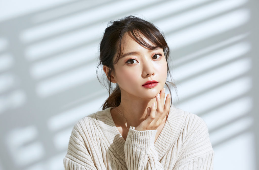 Portrait of young Asian women on light and shadow background showing off beautiful skin after Botox treatment