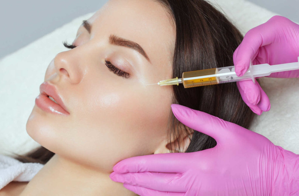 A woman receives a PRP injection.