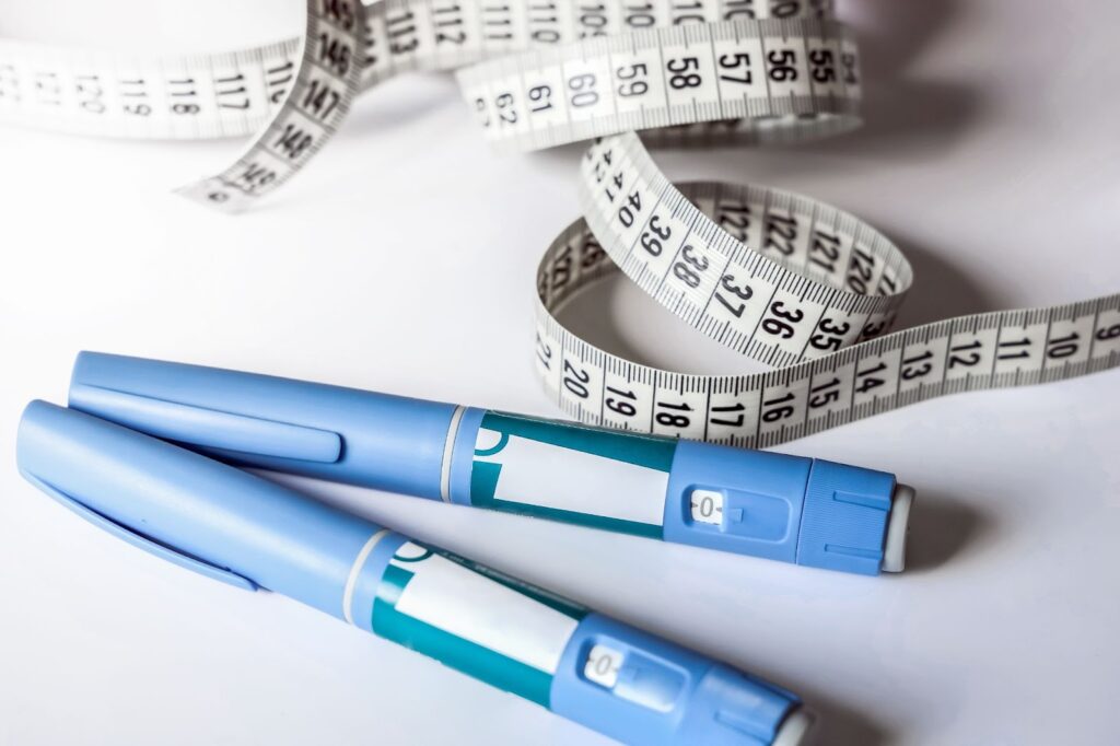 There are two Ozempic injection pens along with a tape measure to help with weight loss and fat-reduction.