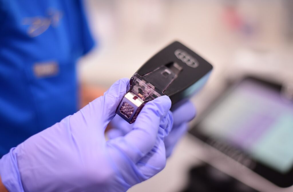 A close up of a gloved hand holding a Morpheus8 tool.