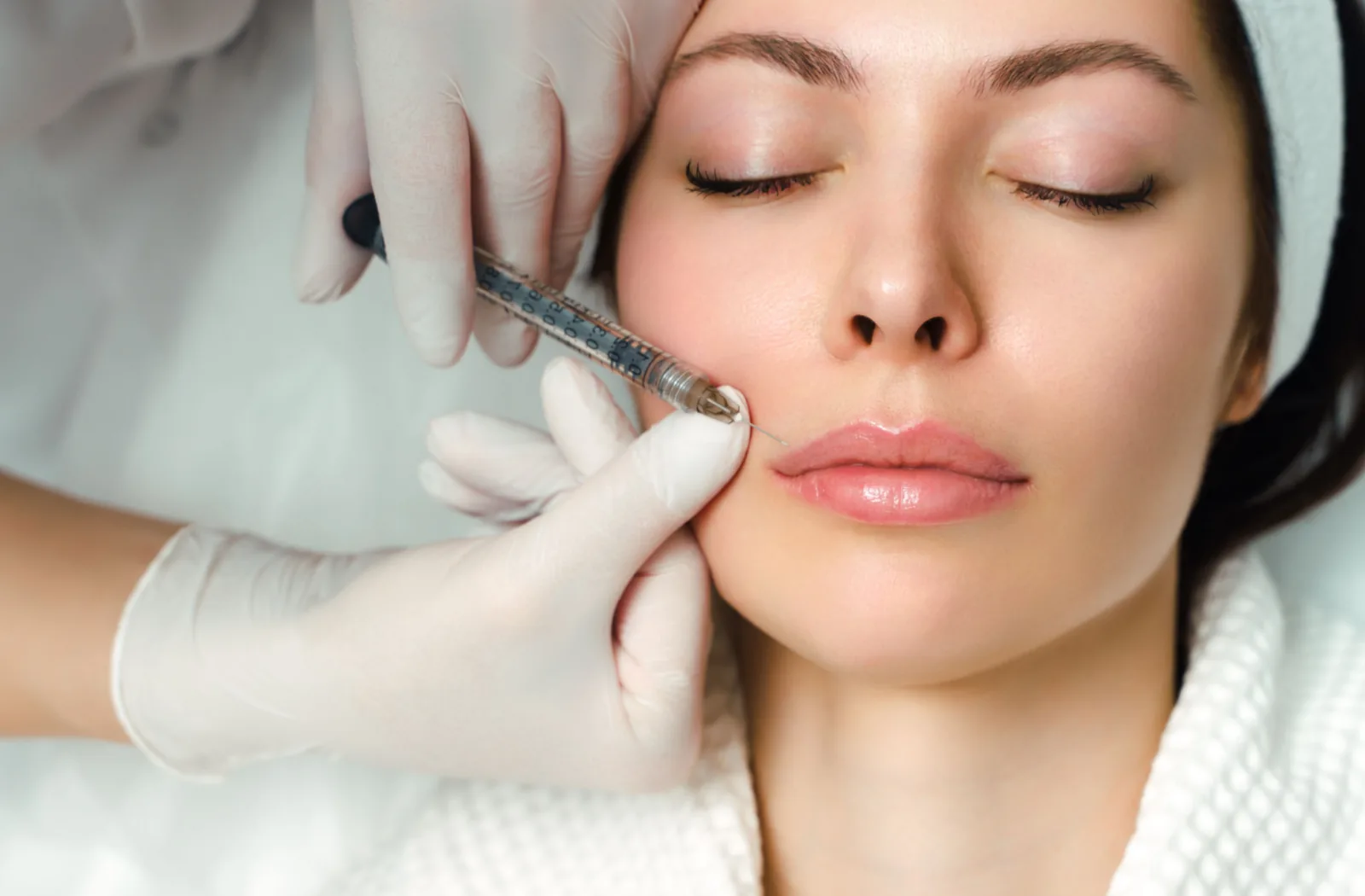 A woman receiving an upper lip injection.